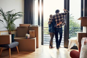 Couple looking out home window